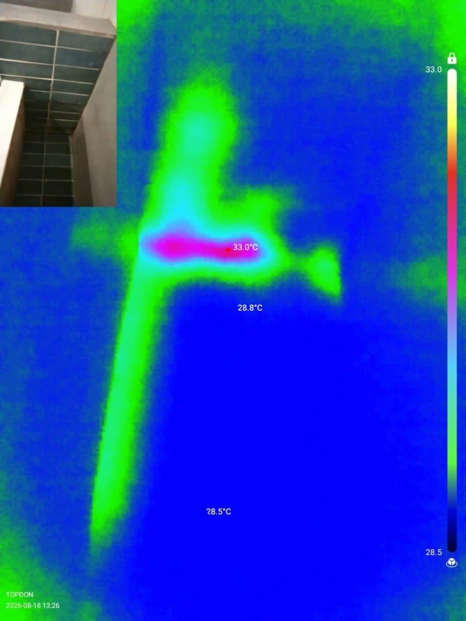 Thermal imaging scan showing temperature anomalies along wall and service-line zones
